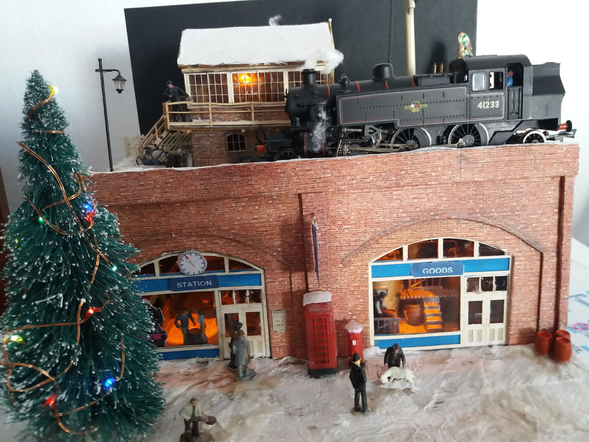 "An #39under the tree#39 Christmas diorama project using 2 x 00-73 oo under arch shop fronts and B 00 – 05 medium signal box. The snow is tissue paper (toilet roll) and the illuminated tree is a £1 shop item strung with cheap led’s from China."