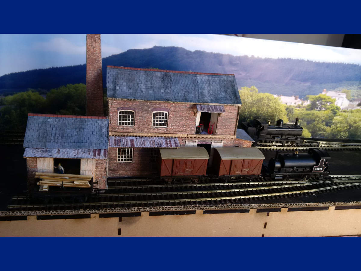 Warehouse, small goods shed and warehouse office combined to create the T Cooper Ltd Barrel makers. Buildings finished with scenic paper.
