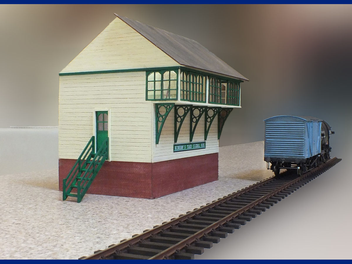 "Ninham's Yard signal box is a freelance, working 3 sided representation of a signal box for my 7mm Shunting Puzzle layout which is at an advanced planning stage. The windows, brackets, bottom brickwork and roof are LCUT products with the rest being a mixture of scored balsa, mdf and sheet plastic. As the box is to be used as an actual signal box and control area (point levers are from DCC Concepts) I used window frames on both sides of the glazing for a better look. All paints are brush applied acrylics"